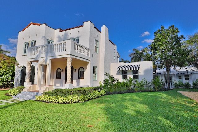 exterior space with a front lawn and a balcony