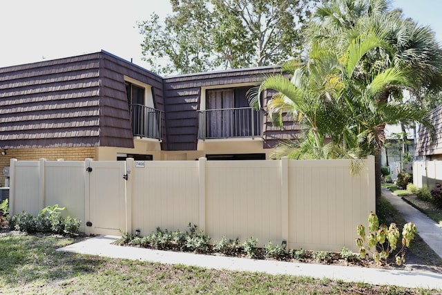 view of side of home with a balcony