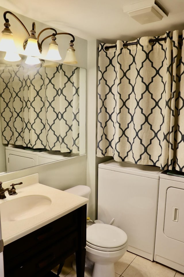 bathroom featuring separate washer and dryer, vanity, tile patterned floors, and toilet