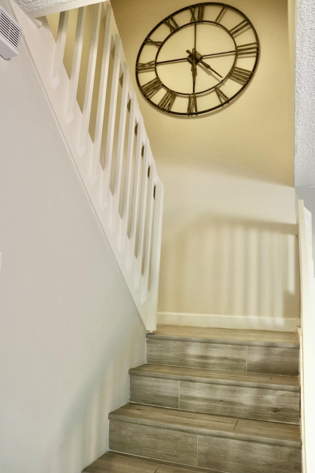 staircase featuring wood-type flooring