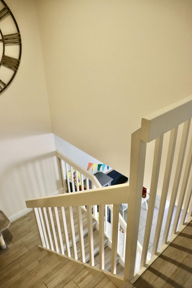 stairs featuring wood-type flooring