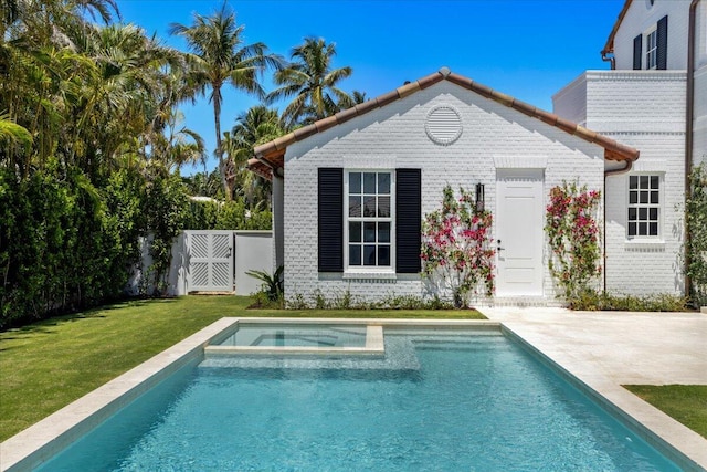 back of property featuring a patio area and a lawn