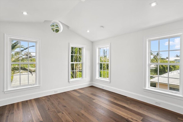 unfurnished room featuring dark wood-type flooring and vaulted ceiling