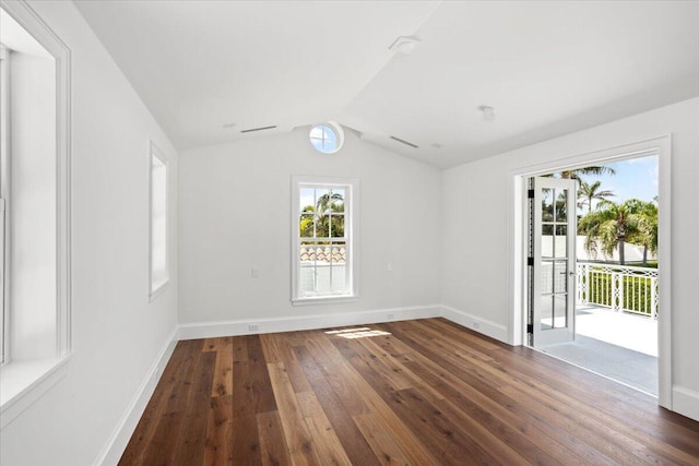 empty room featuring dark wood-type flooring and lofted ceiling