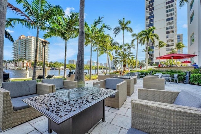 view of patio with a water view and outdoor lounge area