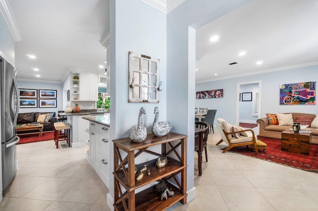 interior space with ornamental molding and light tile patterned floors