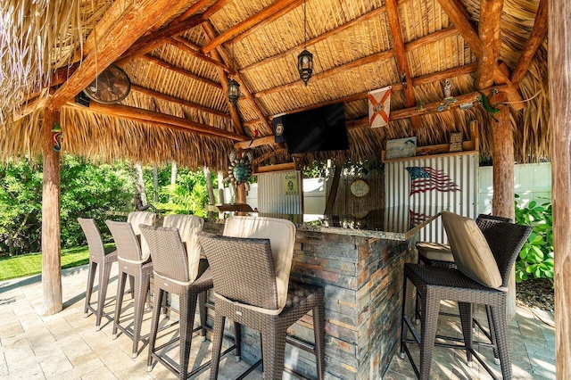 view of patio featuring a bar and a gazebo