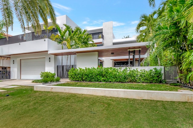 contemporary home featuring a front yard and a garage