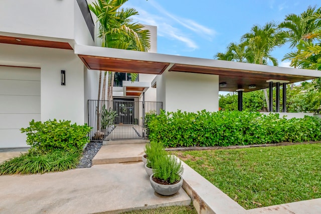 property entrance with a lawn