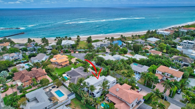 bird's eye view featuring a view of the beach and a water view