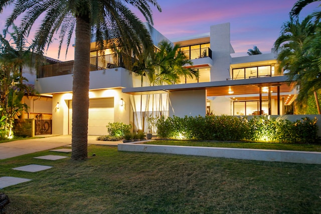 view of front of home featuring a garage and a yard