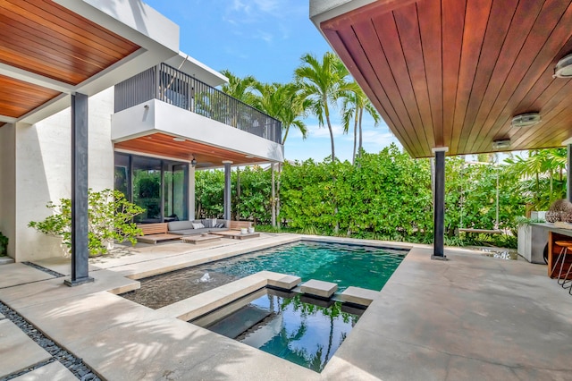 view of pool with a patio and an outdoor living space