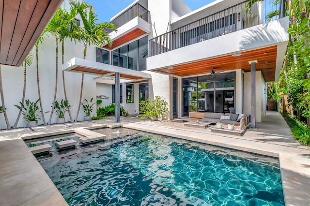 view of swimming pool with an outdoor hangout area, ceiling fan, and a patio