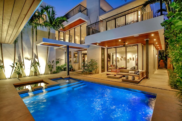 view of pool with a patio area and an outdoor living space