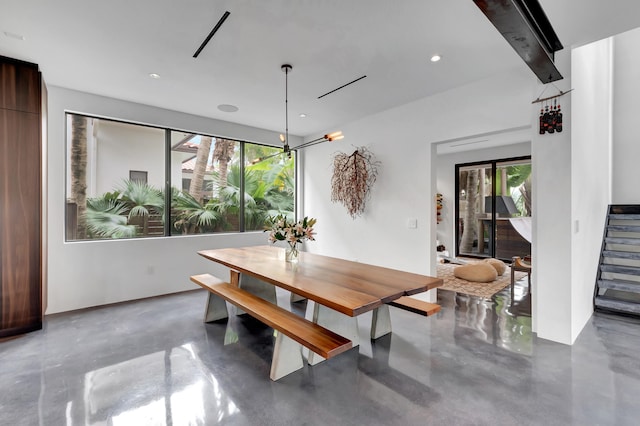 dining space featuring beam ceiling