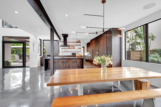 dining area featuring bar and a chandelier