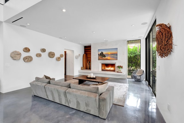 living room with floor to ceiling windows and a fireplace