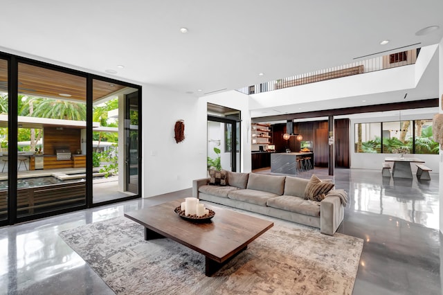 living room featuring plenty of natural light, concrete floors, and expansive windows