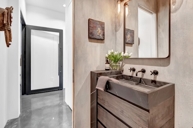 bathroom featuring vanity and concrete flooring