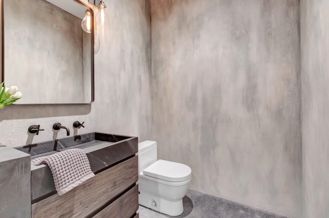 bathroom with toilet and vanity