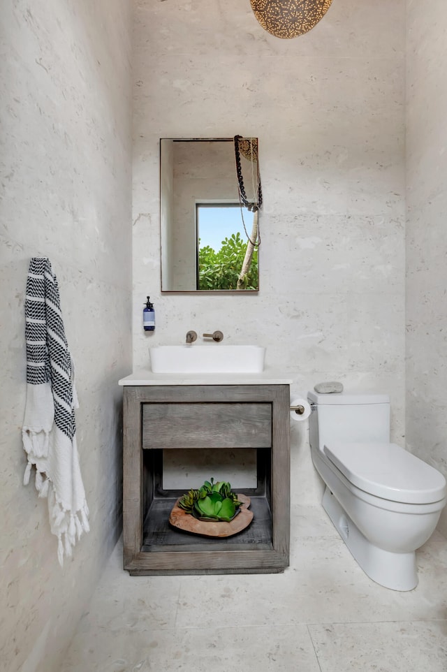 bathroom featuring vanity, tile floors, and toilet