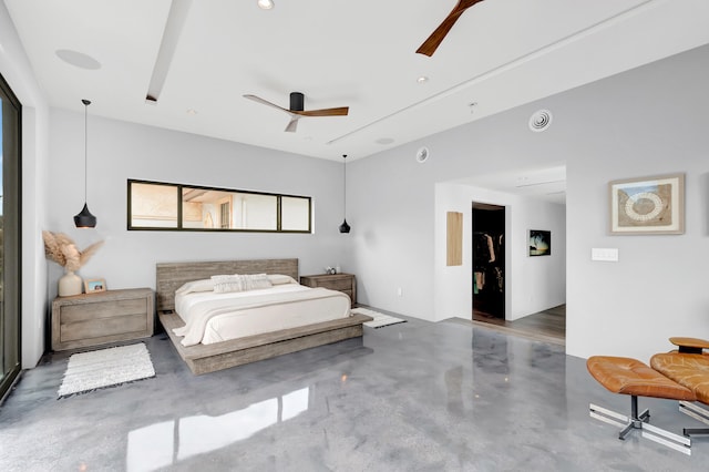 bedroom featuring a spacious closet, a closet, and ceiling fan