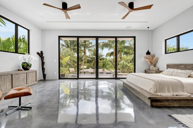 bedroom featuring concrete floors, ceiling fan, and multiple windows