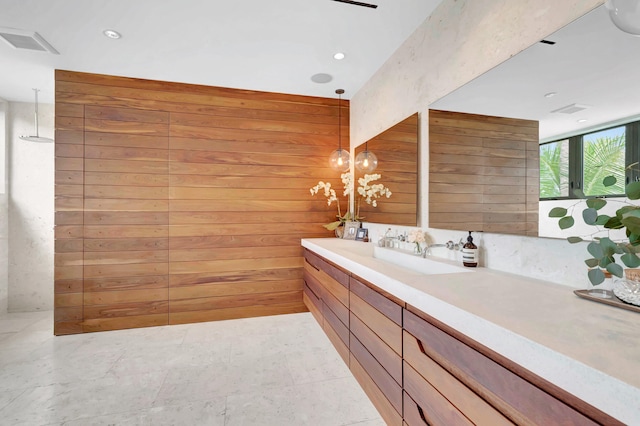 bathroom featuring vanity, wooden walls, and tile floors