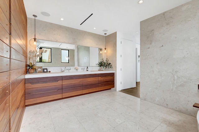 bathroom featuring tile floors, large vanity, and dual sinks