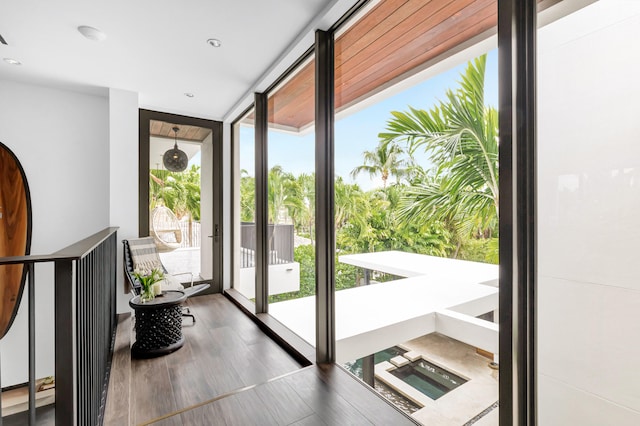 doorway featuring floor to ceiling windows and hardwood / wood-style flooring