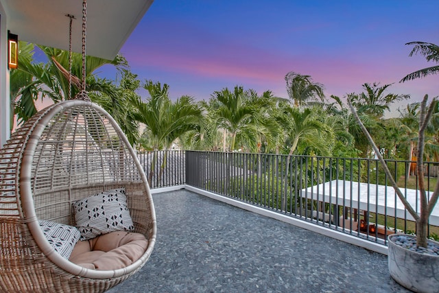 view of balcony at dusk