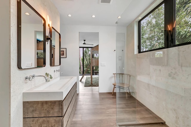 bathroom featuring plenty of natural light, ceiling fan, and vanity