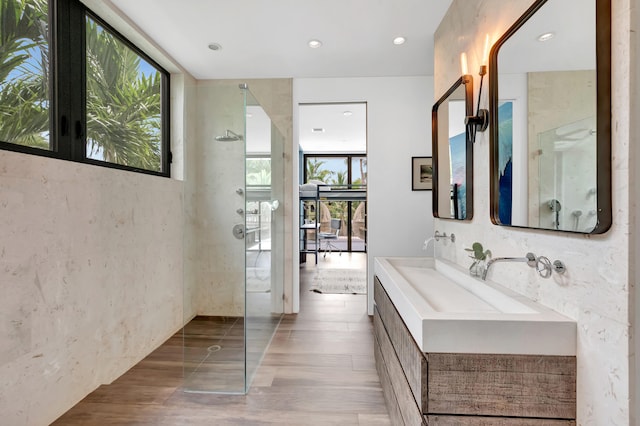 bathroom featuring oversized vanity, independent shower and bath, and wood-type flooring