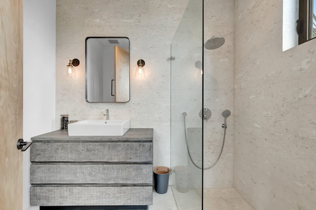 bathroom featuring vanity and a tile shower