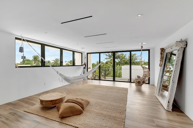 interior space featuring floor to ceiling windows and light hardwood / wood-style floors