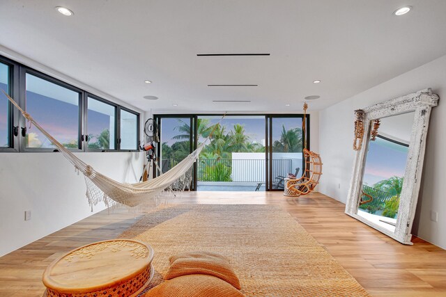 living room featuring light wood-type flooring and a wealth of natural light