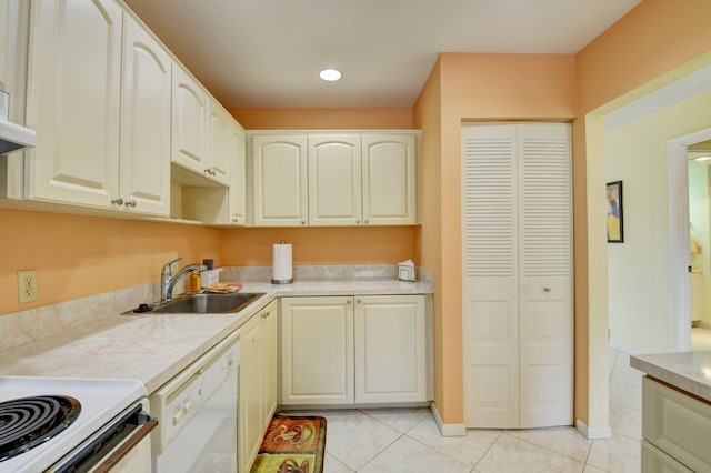 kitchen featuring light tile patterned floors, dishwasher, and sink