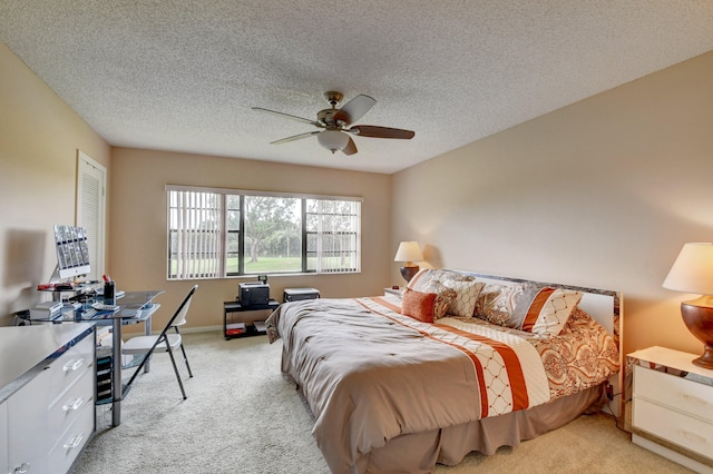 carpeted bedroom with ceiling fan and a textured ceiling