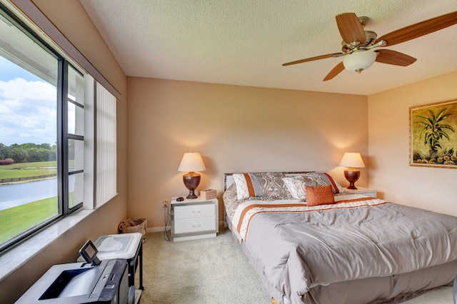 bedroom featuring light carpet, multiple windows, and ceiling fan