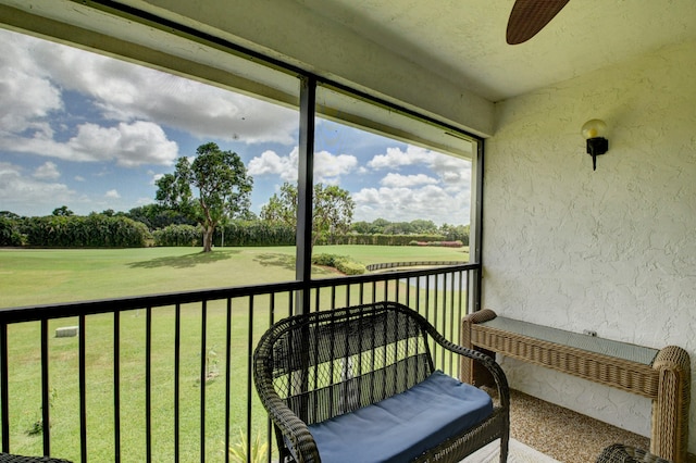 sunroom featuring ceiling fan