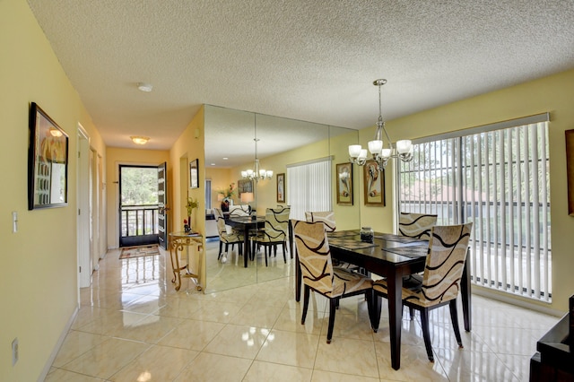 dining room with a chandelier, light tile patterned flooring, and a textured ceiling