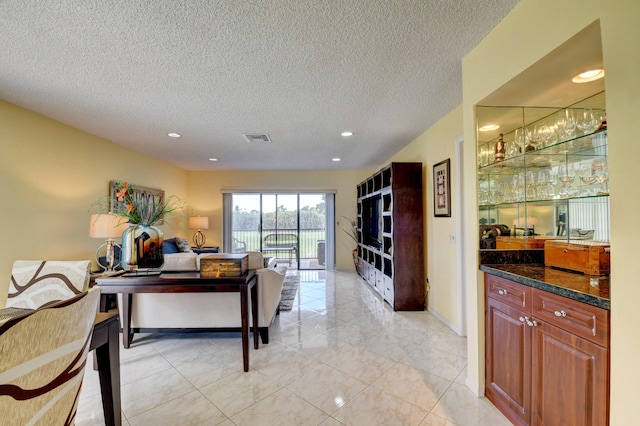 tiled living room with a textured ceiling