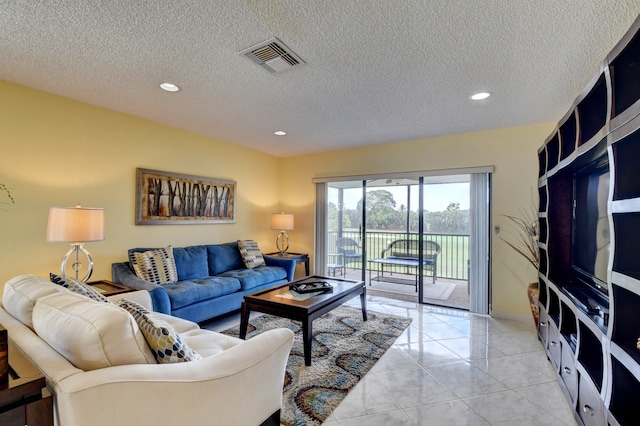 living room with light tile patterned floors and a textured ceiling