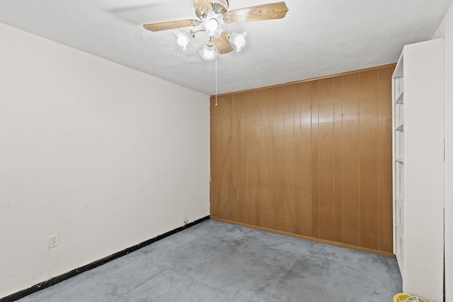 empty room featuring light colored carpet and ceiling fan