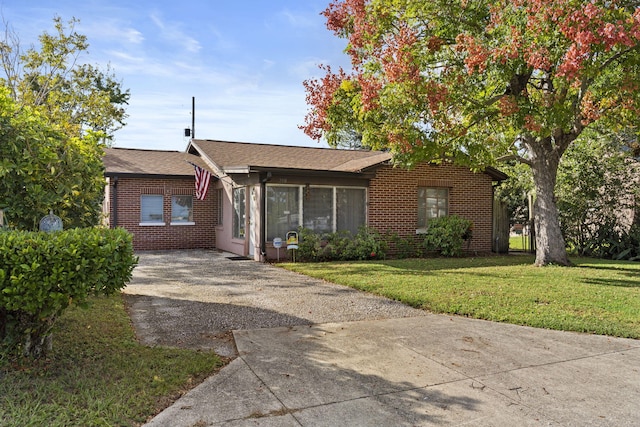 ranch-style home featuring a front yard