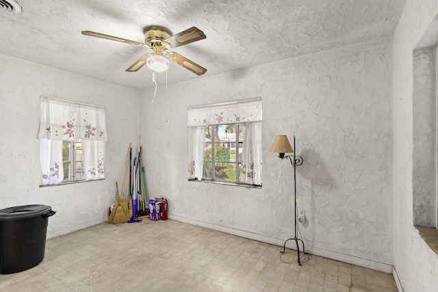 misc room with ceiling fan and light tile floors