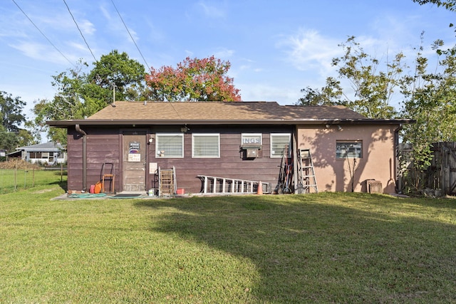 back of house with a yard