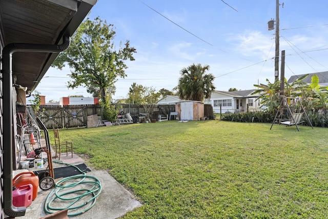 view of yard with a storage shed and a patio area