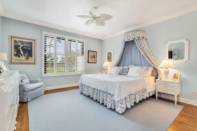 bedroom featuring dark wood-type flooring, ceiling fan, and crown molding