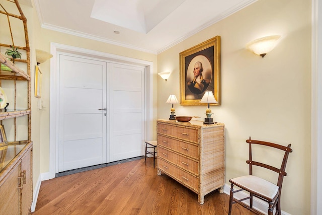 living area featuring crown molding and hardwood / wood-style flooring